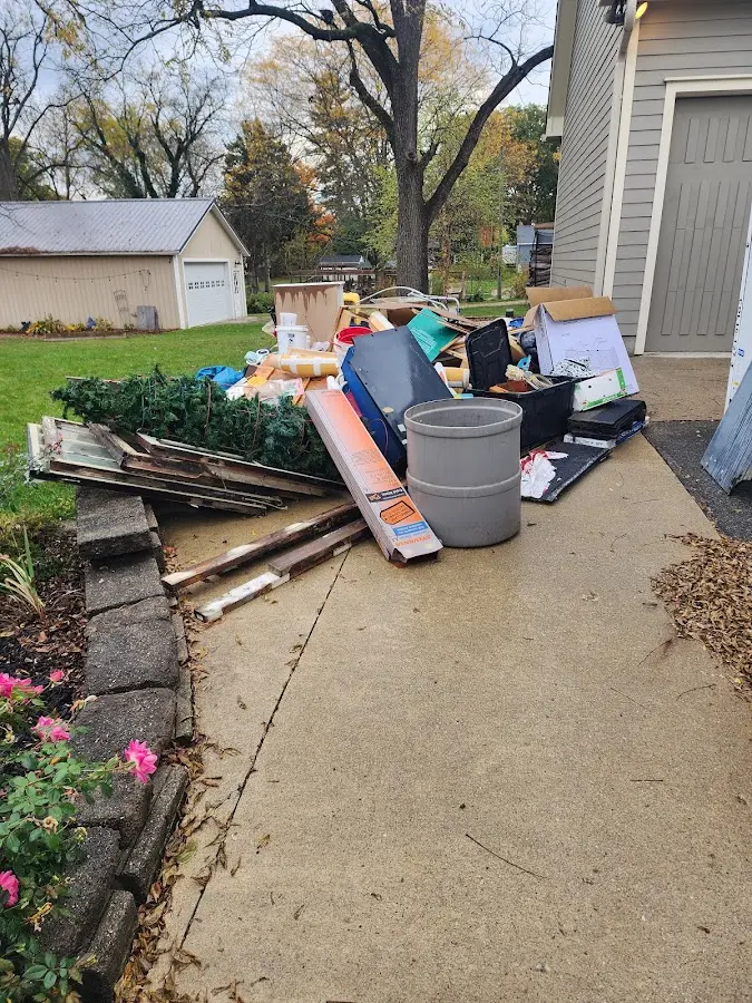 Dumpster being loaded with debris for Roofing Dumpster Rental in Lillington